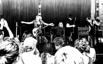 a black and white photo of Cult Objects playing a show